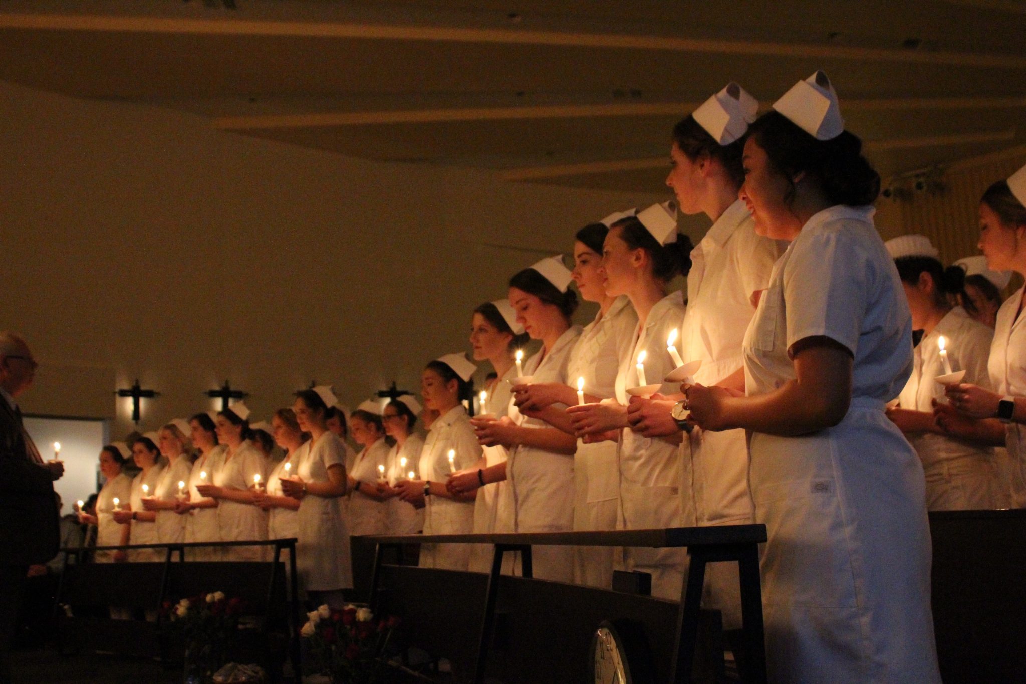 Nursing ceremony lights chapel with candles and students’ radiant